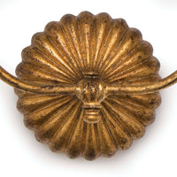 Antique gold leaf double sconce with a ribbed, scalloped backplate.