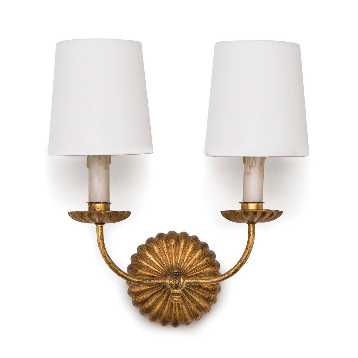 Antique gold leaf double sconce with ribbed backplate, two white linen shades, and candelabra bases.