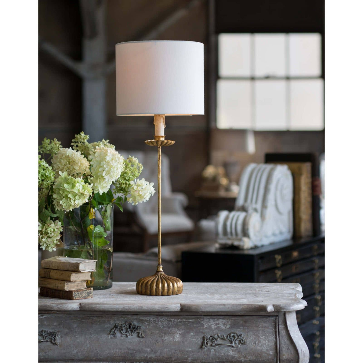 Clove Stem Buffet Table Lamp with an antiqued gold base and natural linen shade.
