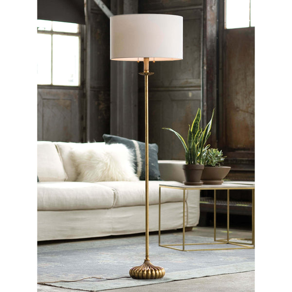 Elegant Clove Stem floor lamp with an antiqued gold leaf finish and a natural linen shade.