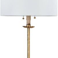 Clove Stem Floor Lamp with antique gold leaf finish and a natural linen rectangular shade.