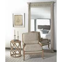 Clover Reclaimed Elm End Table with quatrefoil base, smoke gray finish, next to a beige accent chair.