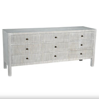 White solid mahogany 9-drawer dresser with vertical textured details and dark round pulls.