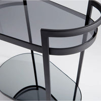 Cosmopolitan black metal bar cart with two oval tempered glass shelves.