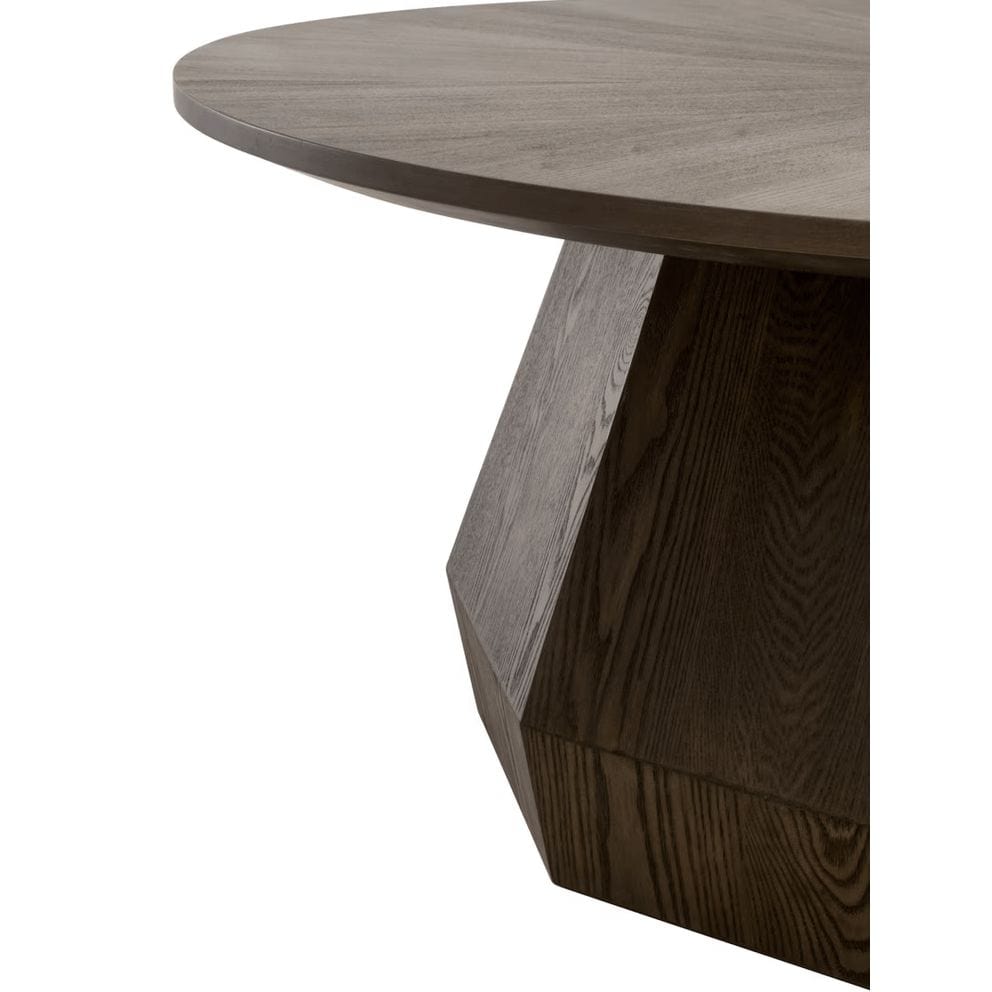 Coulter Burnished Brown Coffee Table with a round top and faceted pedestal base.