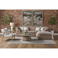 Coulter Natural Gray Ash Coffee Table with timeless design, round shape, and textured finish in a living room.