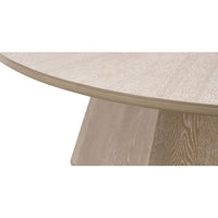 Coulter Natural Gray Ash Coffee Table with round top and modern pedestal base.