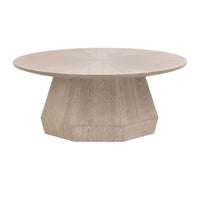 Coulter Natural Gray Ash Coffee Table with round top and faceted pedestal base.