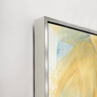 Abstract giclee canvas painting with gold and blue brushstrokes in a silver floating frame.