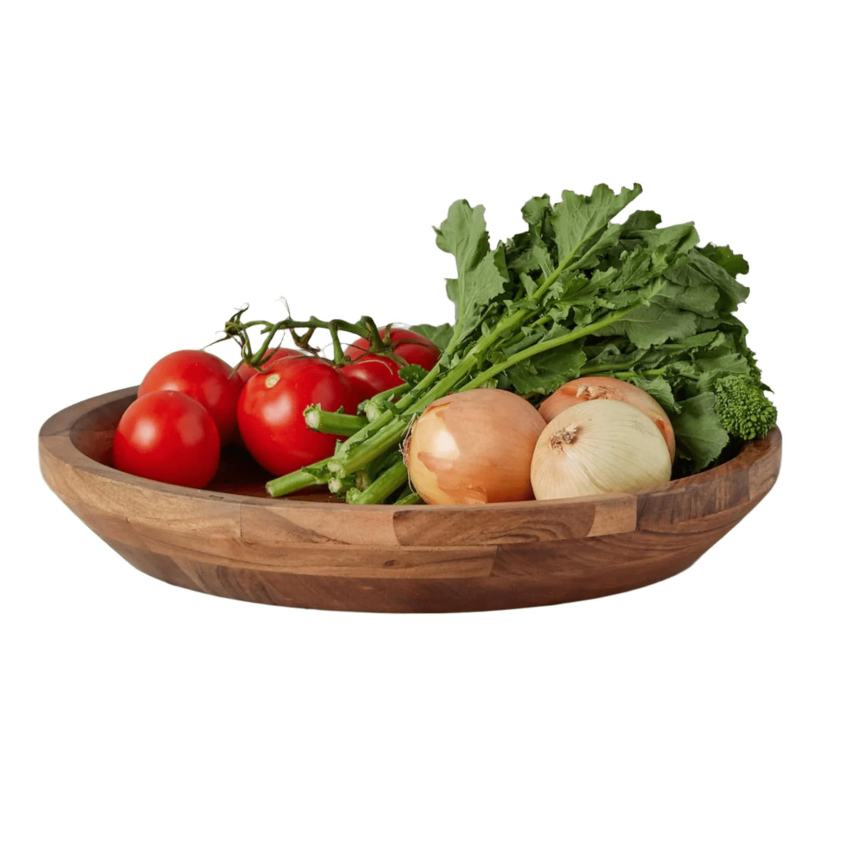 Shallow acacia wood serving bowl filled with fresh red tomatoes, onions, and green leafy vegetables.