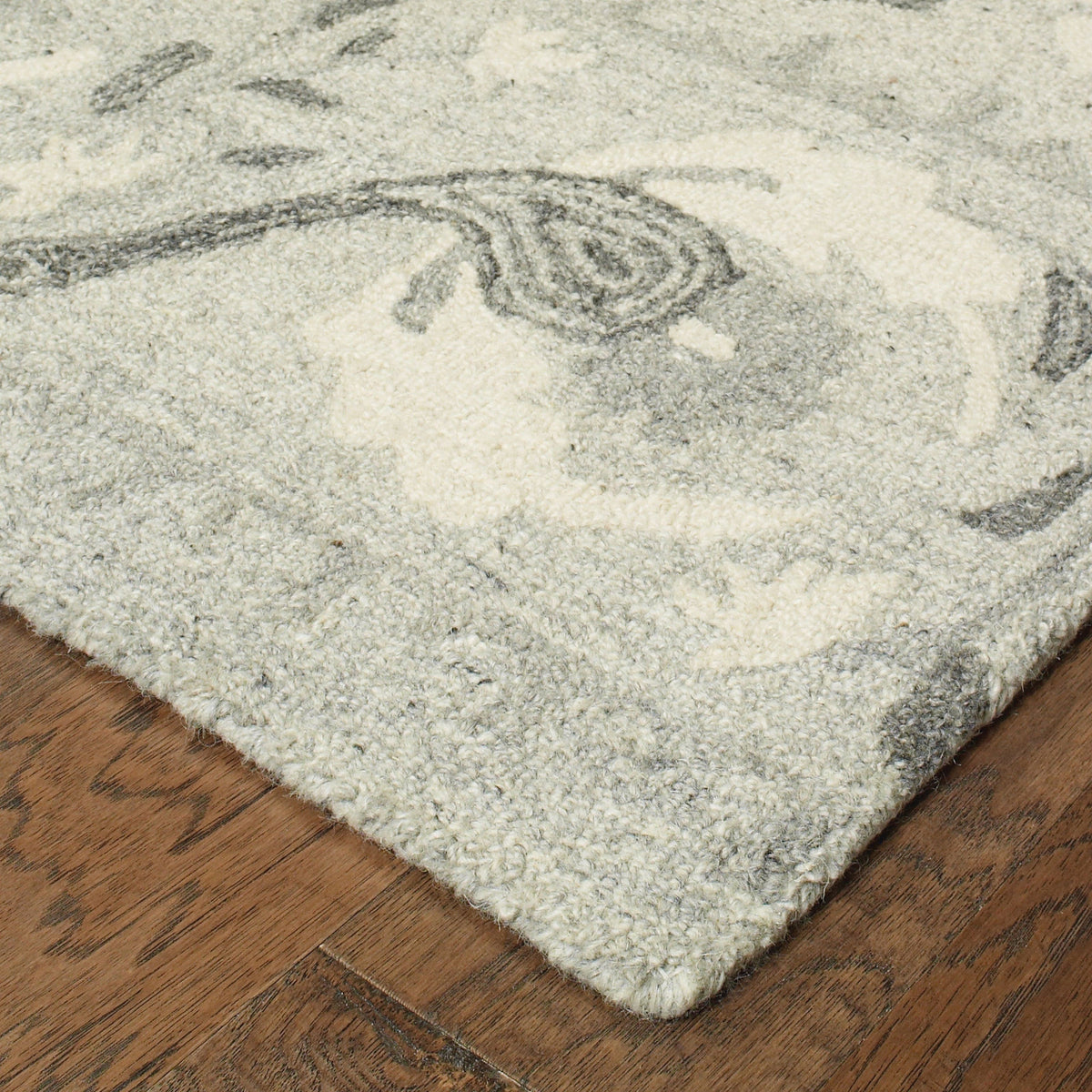Heathered gray and ivory casual wool rug with a soft, looped texture and rustic floral design.