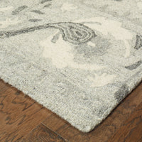 Heathered gray and ivory casual wool rug with a soft, looped texture and rustic floral design.