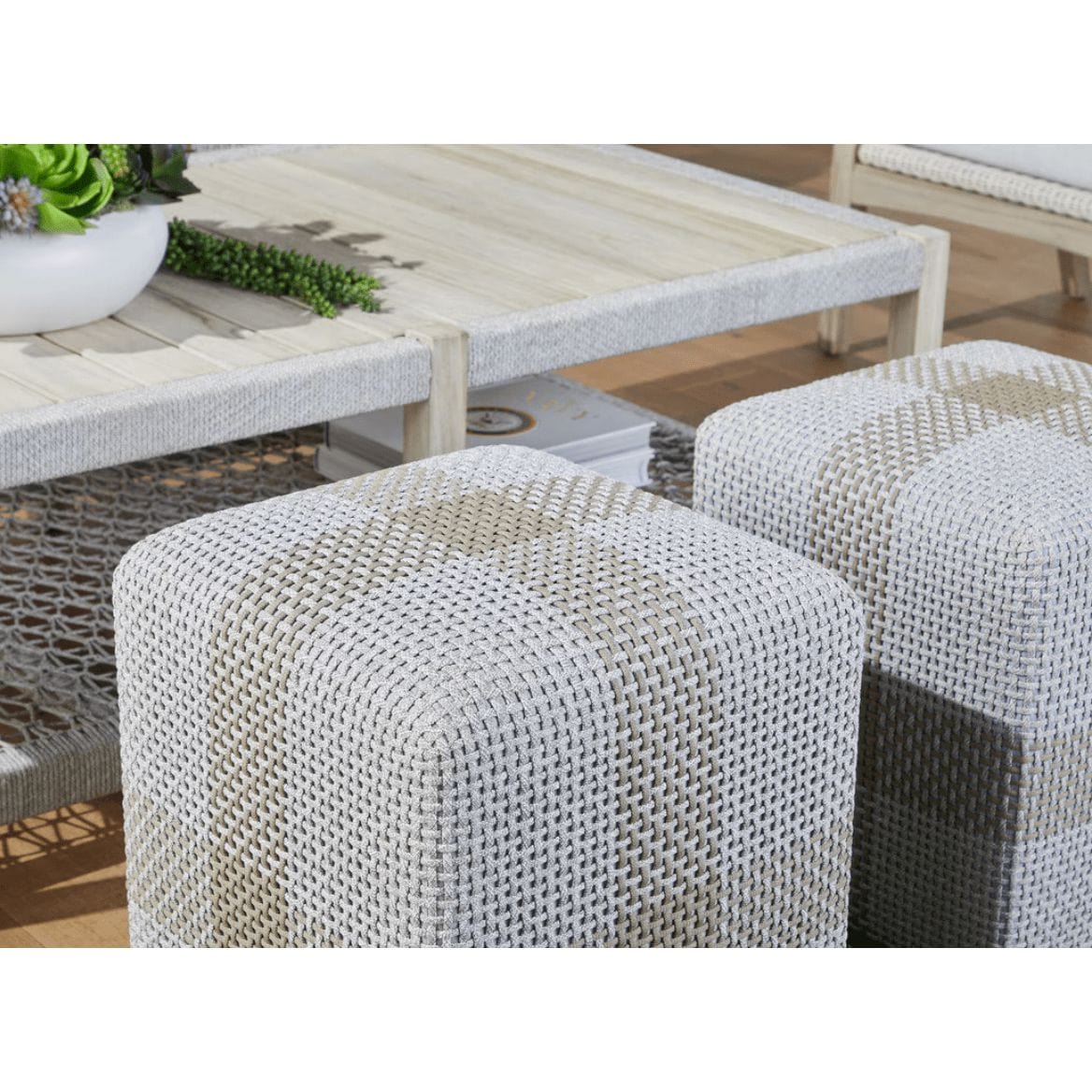 Light gray woven rope ottoman accent cube with a teak wood frame.