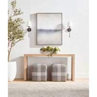Two gray cross rope ottomans with white accents under a light wood console table.