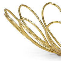 Close-up of a high-shine gold Daisy decorative bowl with sculptural, petal-like loops.