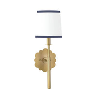 Daisy Sconce with natural brass daisy-shaped backplate and custom natural linen shade with navy trim.