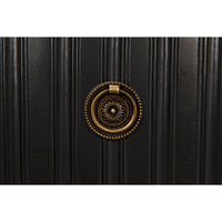 Close-up of a pale black ribbed mahogany dresser with a decorative bronze metal pull.