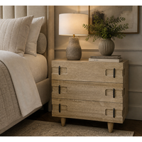 David Walnut Side Table in Washed Walnut, a rustic three-drawer chest with black metal pulls and tapered legs.