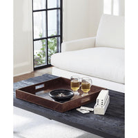 Derby brown square genuine leather tray with built-in handles on a dark wood table, holding drinks and games.
