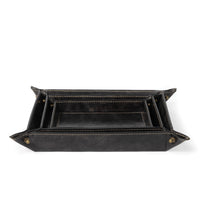 Black genuine leather nesting trays with brass button snaps, modern traditional style.