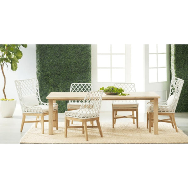 Diego Gray Teak Rectangle Dining Table with natural silver tone finish, surrounded by four white woven chairs.