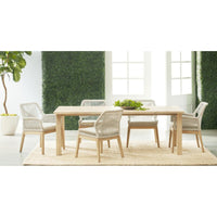 Diego Gray Teak Rectangle Dining Table with four woven chairs on a rug, indoor setting.