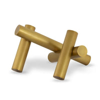Dion Sculpture: Four elegant gold metal cylinders intersecting, creating an abstract, modern design.