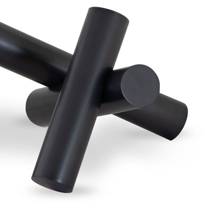 Black Dion Sculpture with four elegant metal cylinders intersecting.