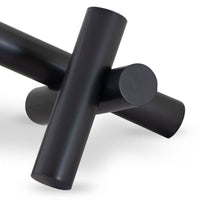Black Dion Sculpture with four elegant metal cylinders intersecting.