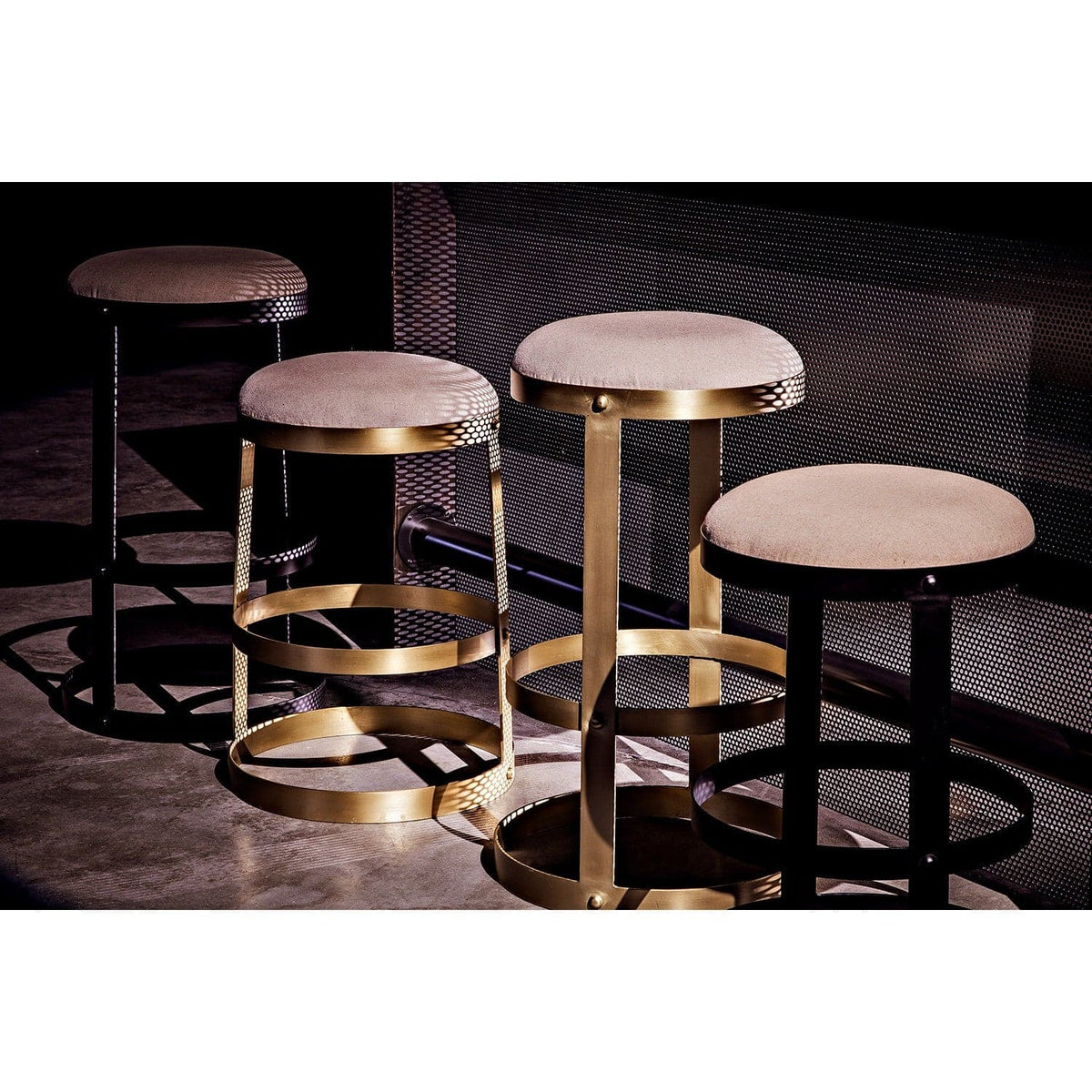 Four Dior Counter Stools: two black steel with linen seats, two antique brass with linen seats.