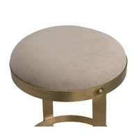 Dior counter stool with a round beige linen seat and antique brass metal base.