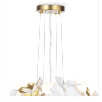 Dogwood Petals Chandelier with matte white and gold leaf floral petals, concealed glass globes, and a gold ceiling mount.