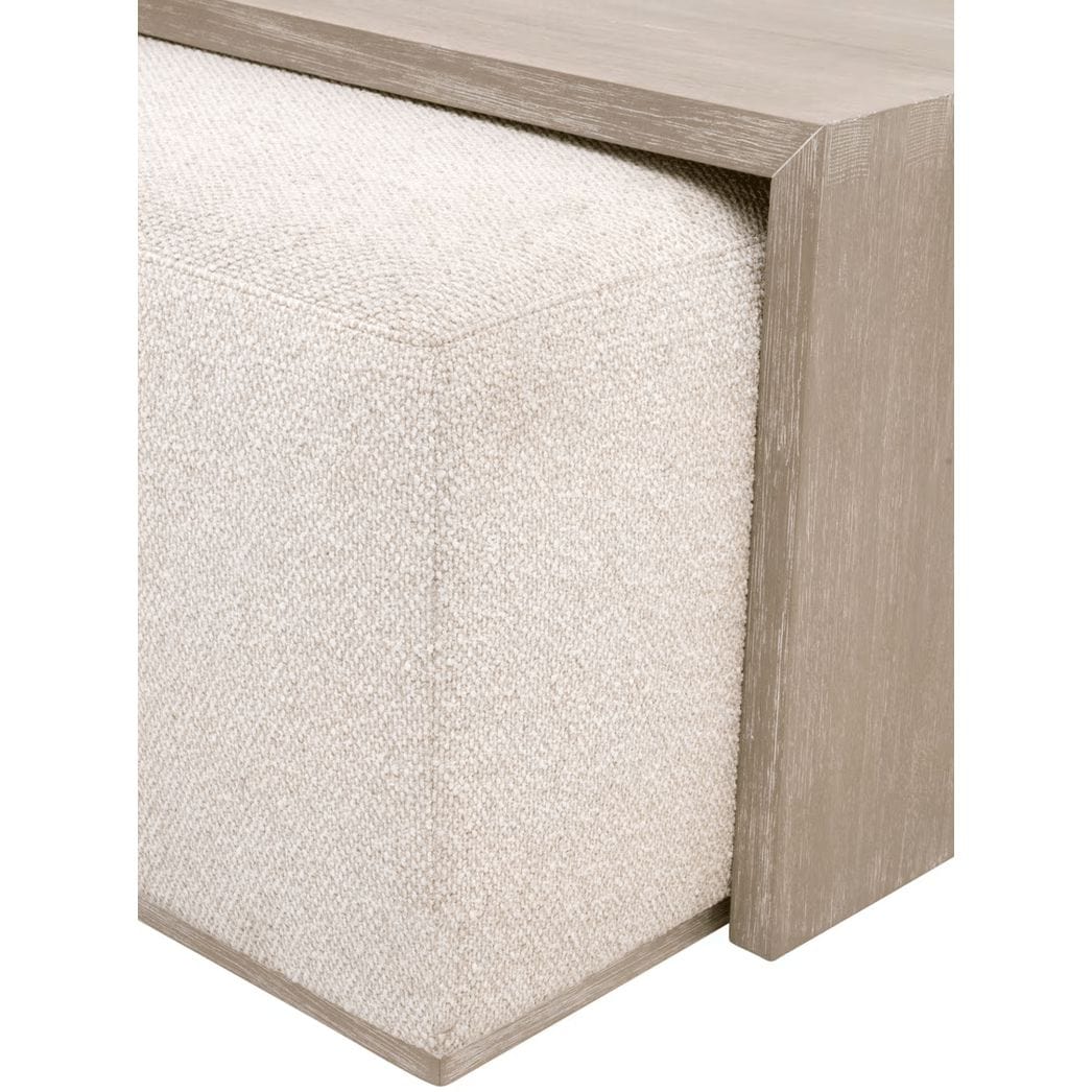 Gray acacia wood coffee table with a removable linen-upholstered ottoman, featuring exposed dovetail joinery.