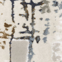Close-up of Easton Grey & Blue Casual Rug with textured abstract design in blue, gray, and brown on a cream background.