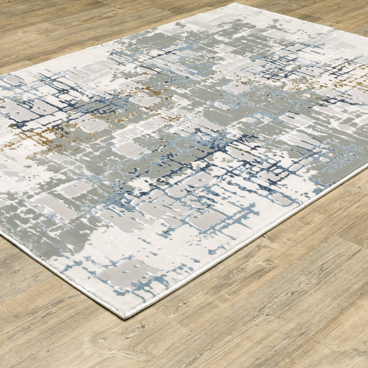 Easton Grey & Blue Casual Rug with abstract textured design on a wood floor.