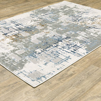 Easton Grey & Blue Casual Rug with abstract textured design on a wood floor.