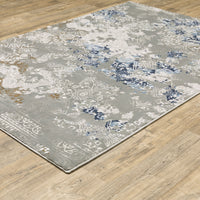Easton Grey & Blue Casual Rug with textured abstract design on a wooden floor.