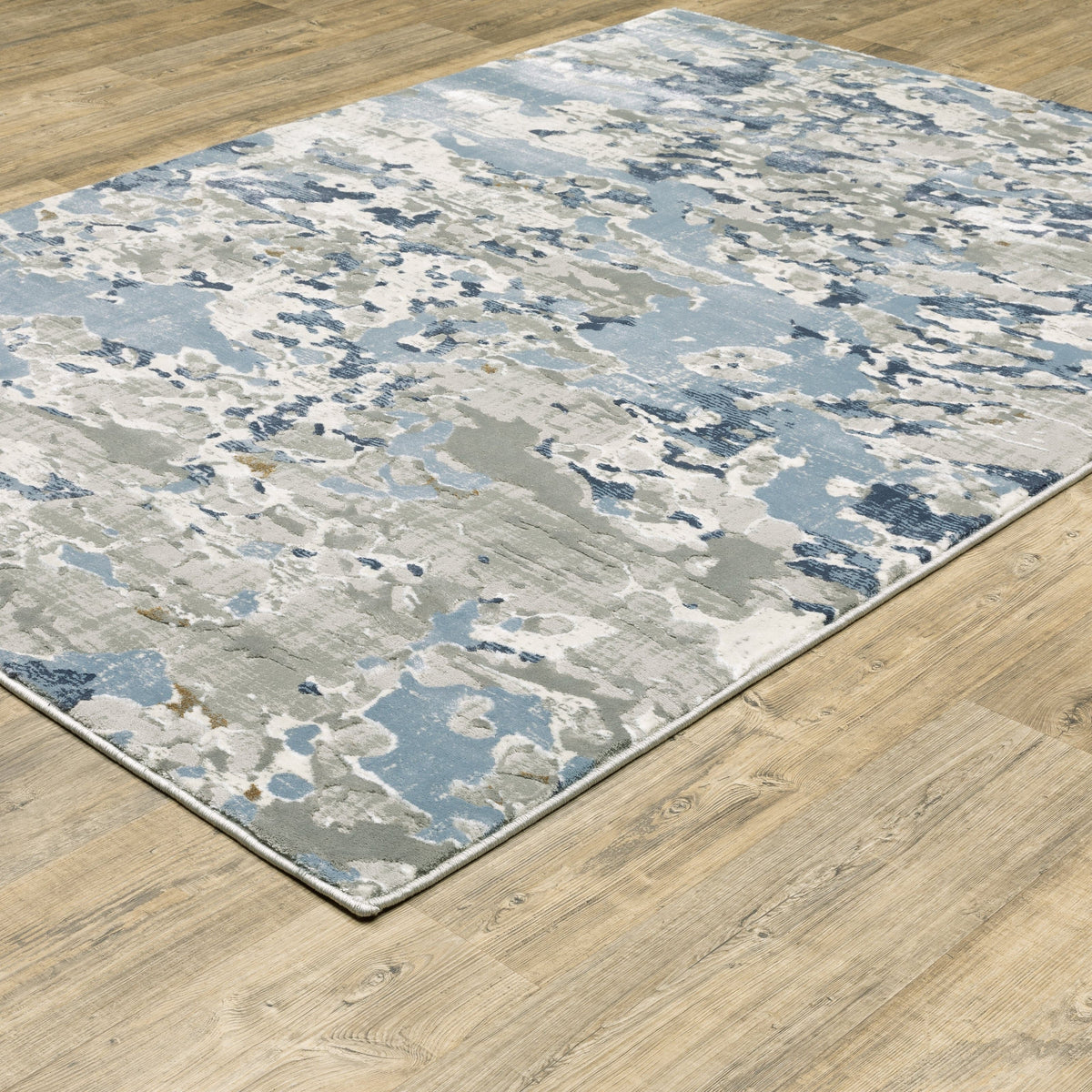 Easton Grey & Blue Casual Rug with abstract design on a wooden floor.