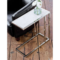Echelon sofa hugger table with white marble top and polished nickel iron frame, next to a black armchair.