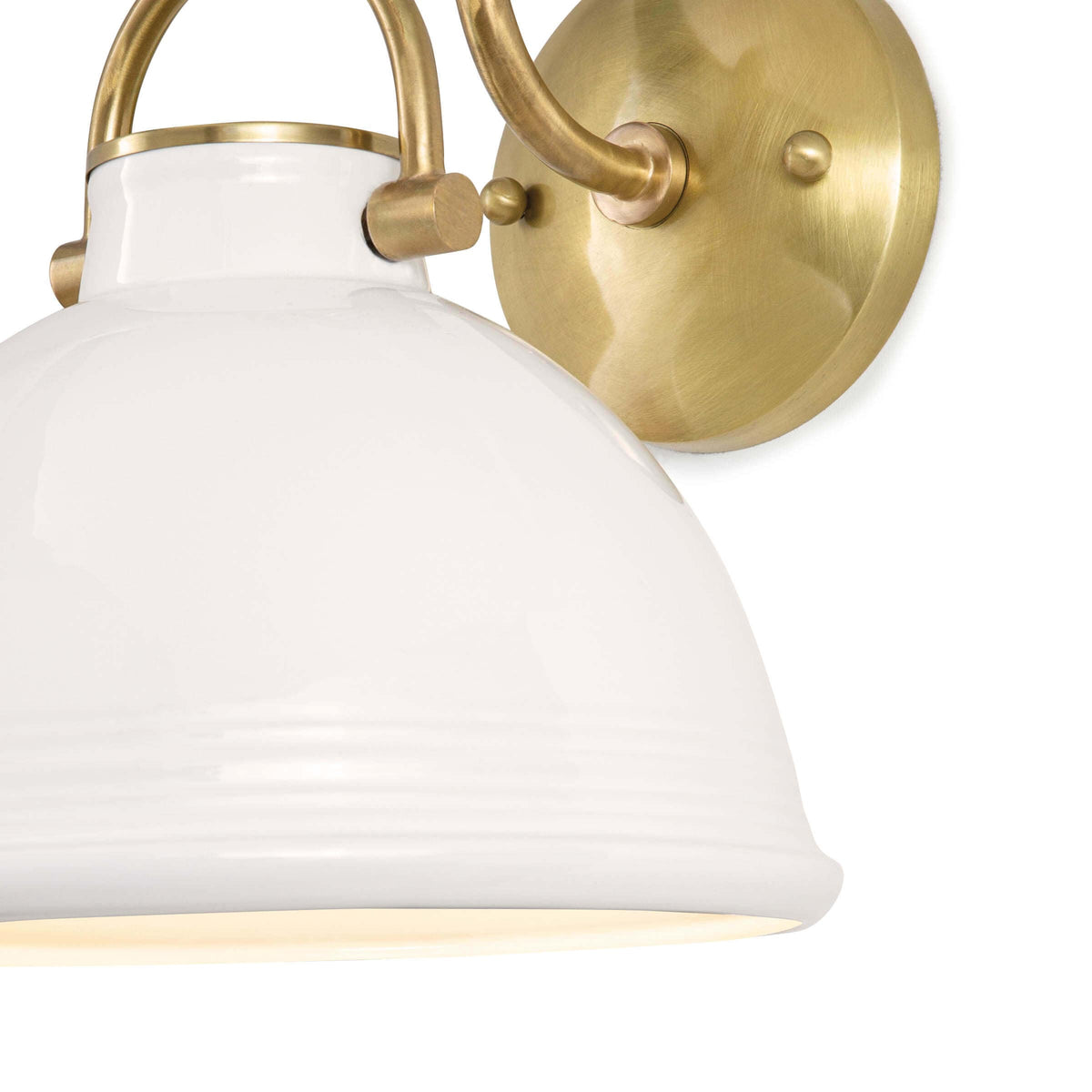 White ceramic Eloise sconce with a ribbed dome shade and natural brass accents.