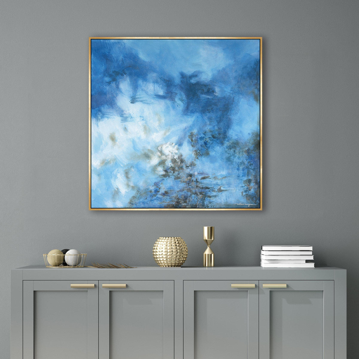 Abstract blue giclee canvas painting with brush gel finish in a gold frame, above a gray console.