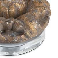 Evette distressed brass resin sculpture on a clear crystal base.