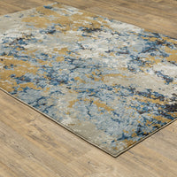 Evolution Blue & Gold Contemporary Rug with abstract landscape design on a wood floor.