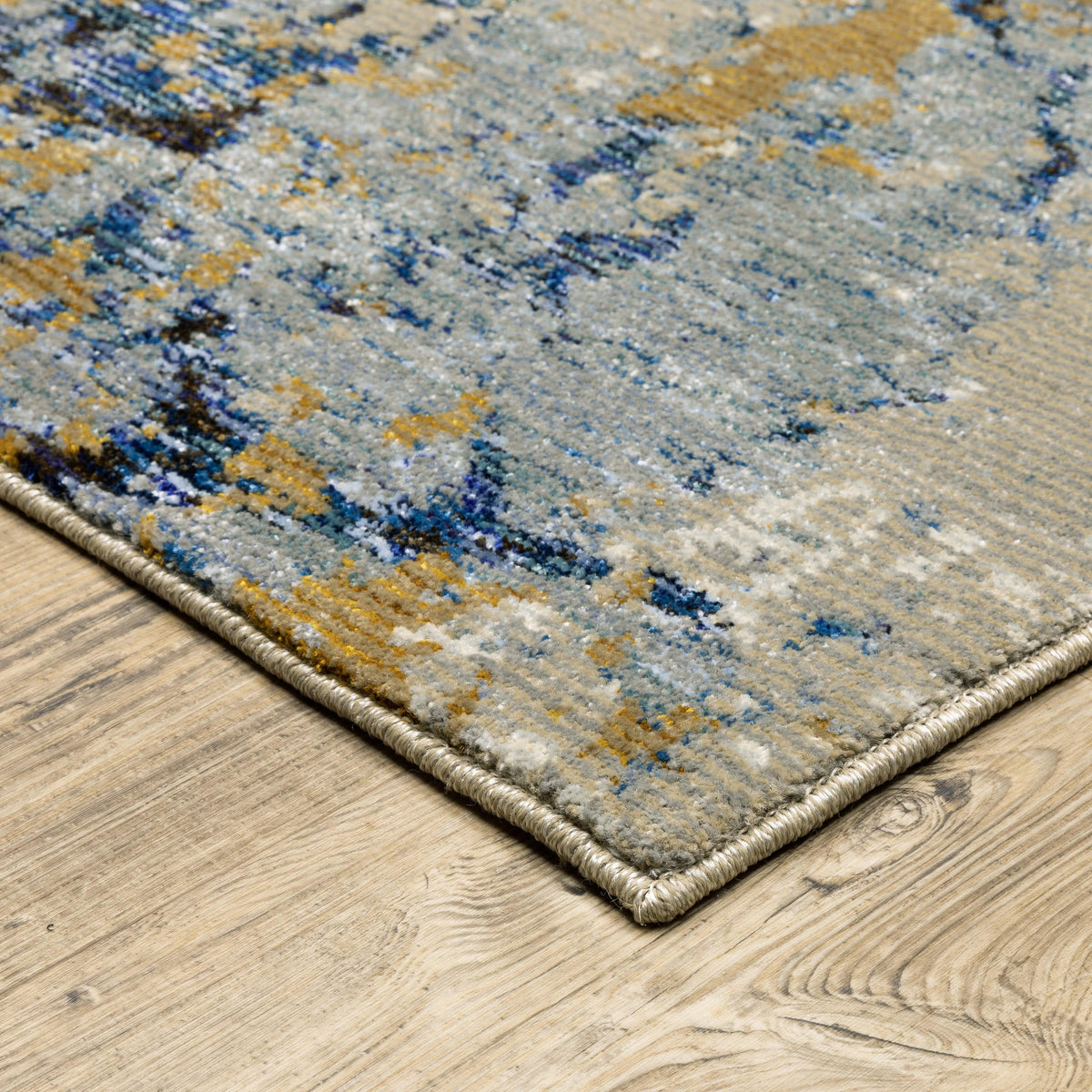Evolution Blue & Gold Contemporary Rug with abstract design, textured nylon/polypropylene blend.