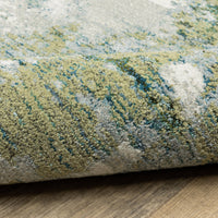 Close-up of an Evolution Blue & Green Contemporary Rug, showing textured nylon/polypropylene fibers.