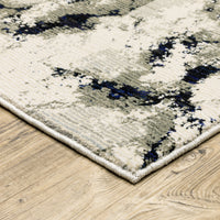 Evolution Contemporary Rug with ivory, charcoal, and black abstract design, featuring shiny and matte yarns on a wood floor.