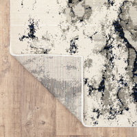 Evolution Contemporary Rug, ivory, charcoal & black, with a corner folded to show woven polypropylene backing.