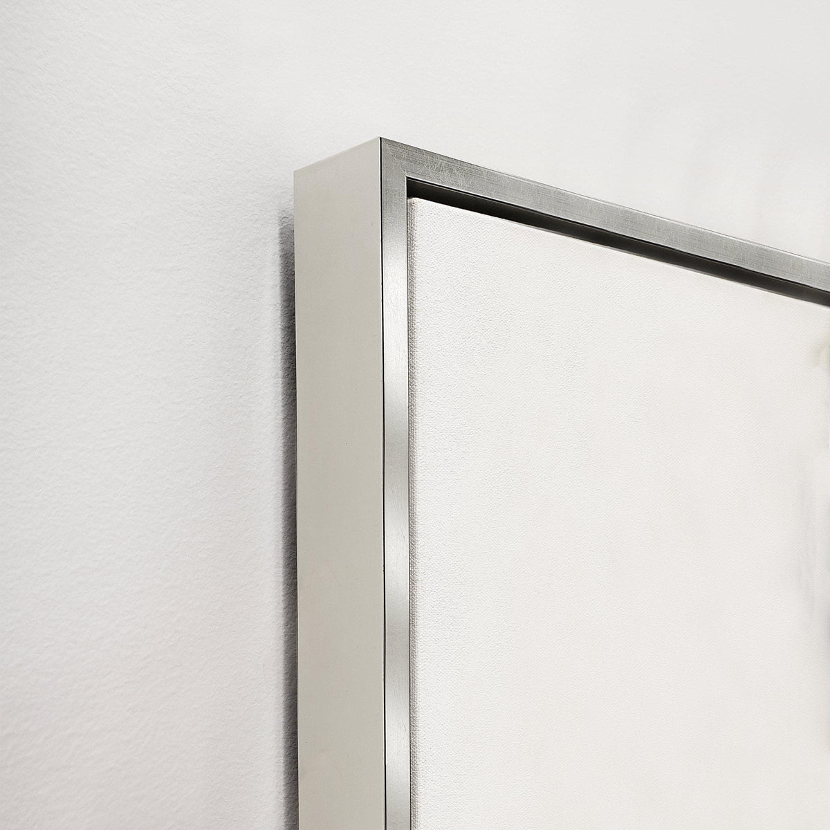 Close-up of a gallery-wrapped giclee canvas painting with a sleek silver frame.