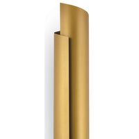 Tall, sleek Flute Sconce in natural brass with a wrapped steel design, casting a soft shadow.