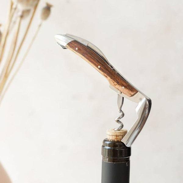 Wine bottle opener with wooden handle and corkscrew on a white background
